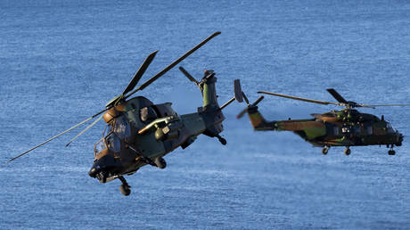 FILE PHOTO: French Tiger attack helicopter together with French NH90 transport helicopter fly during a Joint demonstration as part of the NATO exercise.
