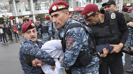 Police detain a demonstrator during a protest rally in Yerevan, May 2, 2022.