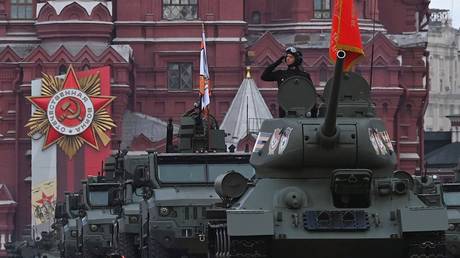 A T-34 Soviet-era tank and Typhoon all-terrain armored vehicles drive during a military parade on Victory Day in Red Square in Moscow, Russia.