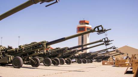 US Marine Corps M777 towed 155 mm howitzers are staged on the flight line prior to being loaded onto a US Air Force C-17 Globemaster III aircraft at March Air Reserve Base, California, April 22, 2022