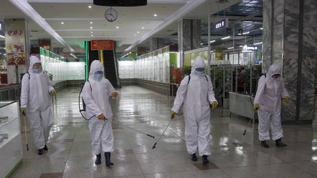 FILE PHOTO: Staff disinfect a store in Pyongyang, North Korea