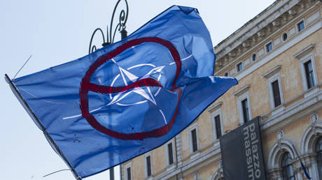 FILE PHOTO. Protester holds a NO NATO flag during a rally in Rome. ©Stefano Costantino / Keystone Press Agency
