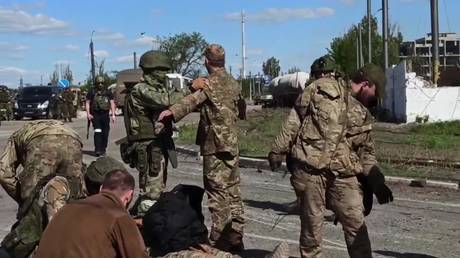 A screen grab taken from a video released by Russian Defense Ministry shows Ukrainian soldiers emerging from Azovstal steel plant in Mariupol, May 17, 2022.
