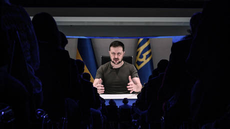 Ukrainian president Volodymyr Zelensky appears on a giant screen during his address by video conference as part of the World Economic Forum (WEF) annual meeting in Davos on May 23, 2022.