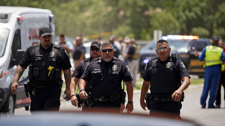 FILE PHOTO: Police walk near Robb Elementary School following a shooting in  in Uvalde, Texas, May 24, 2022