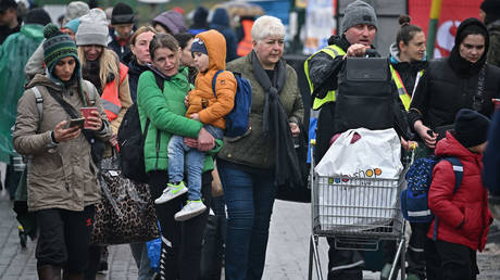 Ukrainian refugees are shown arriving last month at Poland's Medyka border crossing.