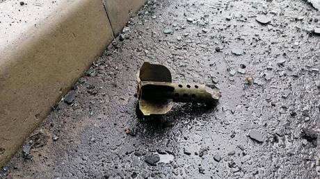 A shell fragment is seen on the ground after an attack in Russia’s Bryansk region. © Sputnik / Julia Zabolotko