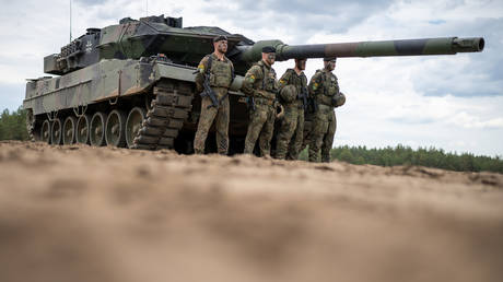FILE PHOTO. A German Army Leopard 2 tank stands during Chancellor Scholz's visit to Camp Adrian Rohn. ©Michael Kappeler / picture alliance via Getty Images
