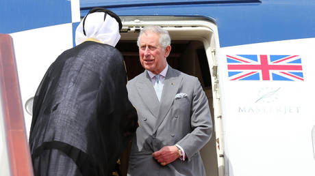 FILE PHOTO: Britain's Prince Charles is welcomed by a Qatari official upon his arrival at Hamad Airport in Doha, Qatar, February 12, 2015