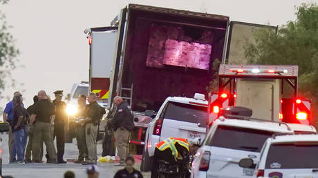 Police and other first responders work the scene where dozens of migrants were found dead in the back of a tractor-trailer, near San Antonio, Texas, June 27, 2022.