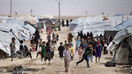 FILE PHOTO: Children gather outside their tents at al-Hol camp, which houses families of members of the Islamic State group, in northeastern Syria, May 1, 2021.