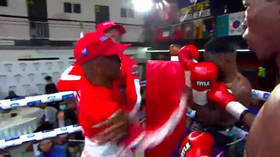 Boxing trainer storms ring to attack fighter's opponent (VIDEO)