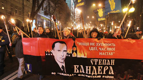 FILE PHOTO: People carry a baner with a portrait of Stepan Bandera during a march of nationalists from different parties dedicated to mark the 110th anniversary of the birth of Ukrainian politician Stepan Bandera, in Kiev, Ukraine. © STR / NurPhoto via Getty Images