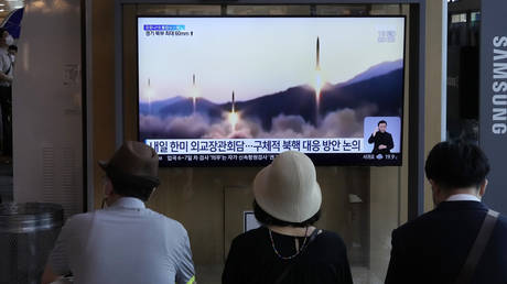 FILE PHOTO: People watch a TV showing a file image of North Korea's missiles launch in Seoul, South Korea, June 13, 2022