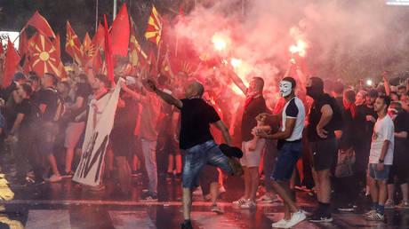 People light flares and throw eggs and stones during a protest in Skopje, North Macedonia on July 5, 2022.