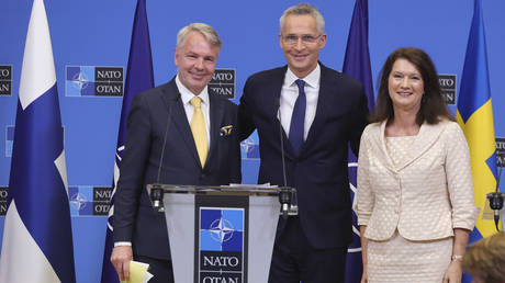 Finland's Foreign Minister Pekka Haavisto, left, Sweden's Foreign Minister Ann Linde, right, and NATO Secretary General Jens Stoltenberg.