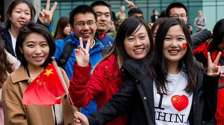 Chinese students in Manchester, England, are shown welcoming President Xi Jinping during his October 2015 state visit to the UK.
