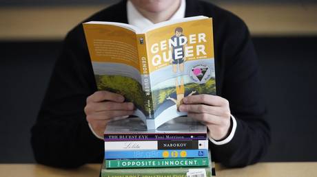 FILE PHOTO: Utah Pride Center director poses with books that have been the subject of complaints from parents, December 16, 2021