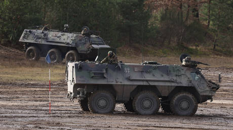 FILE PHOTO. Bundeswehr soldiers ride Fuchs armored vehicles.