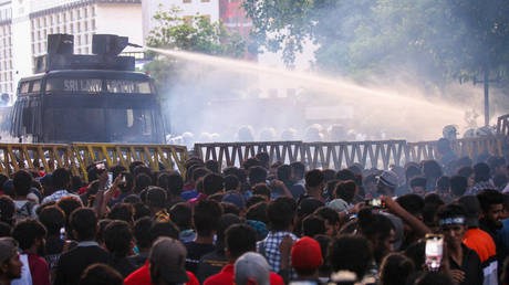 Police use a water canon to disperse demonstrators demanding the resignation of Sri Lanka's President Gotabaya Rajapaksa over the country's crippling economic crisis, in Colombo on July 8, 2022.