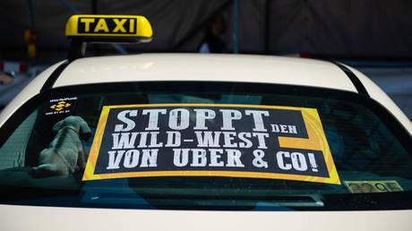 FILE PHOTO. A taxi with protests against the Uber in Berlin. ©Lisa Ducret / picture alliance via Getty Images