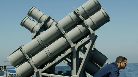 FILE PHOTO. A sailor stands next to a Harpoon Mark 7 missile launcher aboard the USS San Jacinto. YMark Wilson / Getty Images