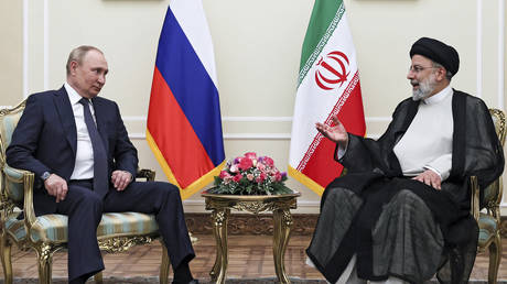 Russian President Vladimir Putin, left, listens to Iranian President Ebrahim Raisi during their talks at the Saadabad palace, in Tehran, Iran, Iran, Tuesday, July 19, 2022.