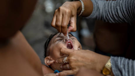 FILE PHOTO: Oral polio vaccines with live, weakened versions of the virus are still used in many countries, as shown in an October 2019 inoculation campaign in Manila.