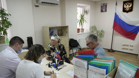 People receive Russian passports in Kherson, Ukraine, July 21, 2022.