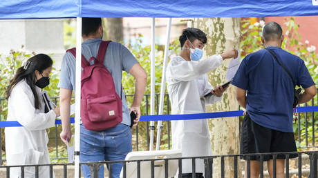 Healthcare workers help people register for the monkeypox vaccine in New York City, July 26, 2022, in New York.