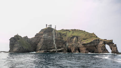 Dongdo (East Island) with a lighthouse of the Dokdo Islets is seen from a ferry, South Korea.