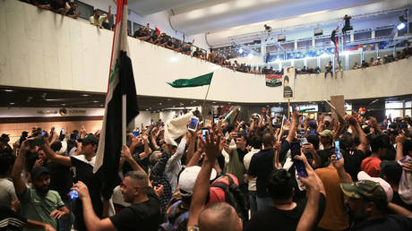 Supporters of Iraq's influential Shiite cleric Moqtada al-Sadr protest inside the Iraqi Parliament on July 30, 2022.