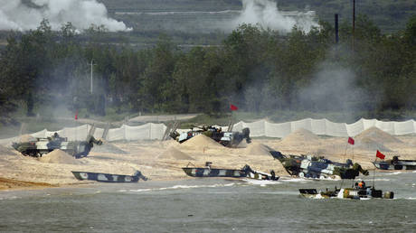 FILE PHOTO. Amphibious tanks of the Chinese People's Liberation Army land a beach near Qingdao of Shandong Peninsular, China.