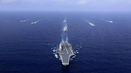 FILE PHOTO. China's sole operational aircraft carrier, the Liaoning (C), sailing during a drill at sea.