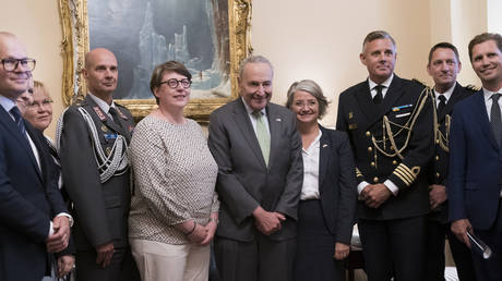 Senate Majority Leader Chuck Schumer, D-N.Y., center, is flanked by Paivi Nevala, minister counselor of the Finnish Embassy, left, and Karin Olofsdotter, Sweden's ambassador to the US, at the Capitol in Washington, August 3, 2022