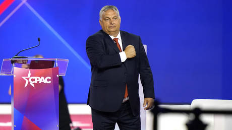 Hungarian Prime Minister Viktor Orban waves his fist to the chest after speaking at the Conservative Political Action Conference (CPAC) in Dallas, Texas on August 4, 2022