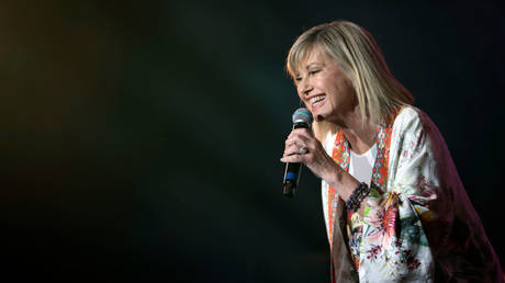 Olivia Newton-John is shown performing at a February 2020 benefit concert in Sydney.