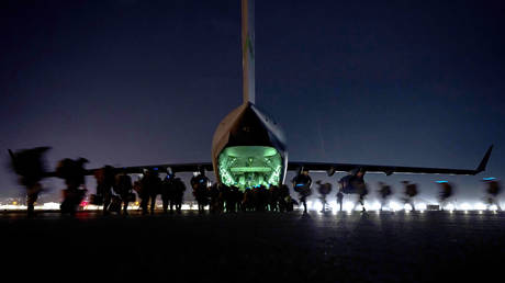 FILE PHOTO. U.S. Army 82nd Airborne Division paratroopers board an Air Force C-17 Globemaster III cargo plane as the last American soldiers prepare to leave Afghanistan at Hamid Karzai International Airport August 30, 2021 in Kabul, Afghanistan.