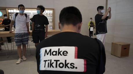 FILE PHOTO: A man wearing a shirt promoting TikTok is seen at an Apple store in Beijing, China, July 17, 2020