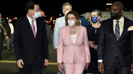 US House Speaker Nancy Pelosi (C) being welcomed by Taiwanese Foreign Minister Joseph Wu (L) after landing at Songshan Airport in Taipei, Taiwan on August 2, 2022. © Taiwanese Foreign Ministry / Handout / Anadolu Agency via Getty Images