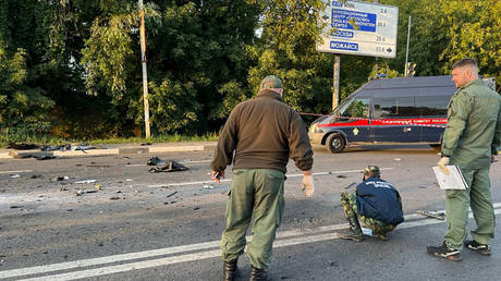 investigators work on the place of explosion of a car driven by Daria Dugina, daughter of Alexader Dugin, outside Moscow.