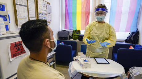 A physician goes over the possible side effects with a patient before administering a monkeypox vaccine during a vaccination clinic at the OASIS Wellness Center, August 19, 2022, in New York