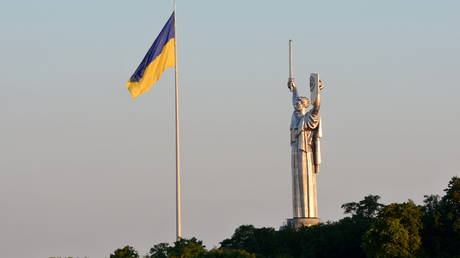 Ukraine's biggest flag flies some 90 metres above the city as it has been installed on the eve of the State Flag Day, with the Motherland Monument at centre in Kyiv. © Aleksandr Gusev / Pacific Press / LightRocket via Getty Images