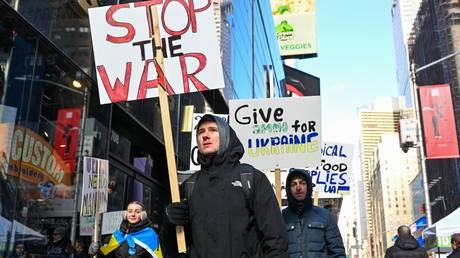 Demonstrators are shown marching in support of Ukraine last February in New York City, two days after the Russian offensive began.