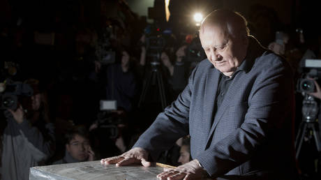 FILE PHOTO: Former Soviet Leader, Mikhail Gorbachev, presses his hands in concrete attached to a piece of the Berlin wall during a reception at the Checkpoint Charlie in Berlin, Germany, November 7, 2014