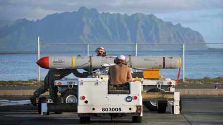 FILE PHOTO: US sailors load a AGM-84D Harpoon missile onto a P-8A Poseidon aircraft during RIMPAC exercise in Hawaii, July 12, 2018