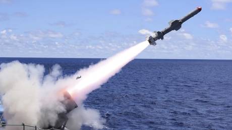 FILE PHOTO: A US guided-missile cruiser launches a Harpoon missile during a drill in the Philippine Sea, May 26, 2019.
