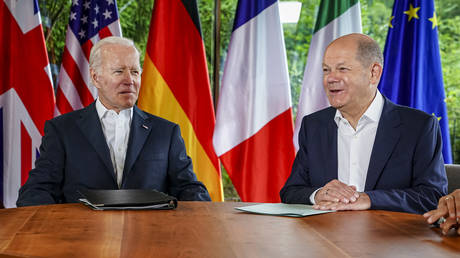 FILE PHOTO: US President Joe Biden (L) and German Chancellor Olaf Scholz talk at the G7 meeting at the Elmau Castle, Germany, on June 28, 2022.