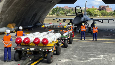 Military personnel stand next to U.S. Harpoon A-84, anti-ship missiles and AIM-120 and AIM-9 air-to-air missiles at the Hualien Airbase, Taiwan, 2022