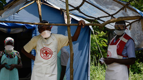 FILE PHOTO: Health workers stand a checkpoint during an outbreak of Ebola in Uganda.